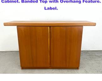 Lot 1189 SUN CABINET MCM Teak Two Door Cabinet. Banded Top with Overhang Feature. Label. 