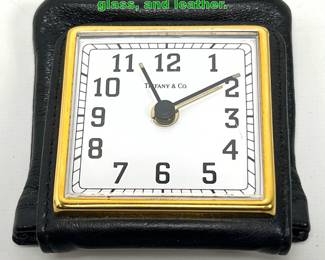 Lot 1690 Tiffany travel alarm clock in metal, glass, and leather.