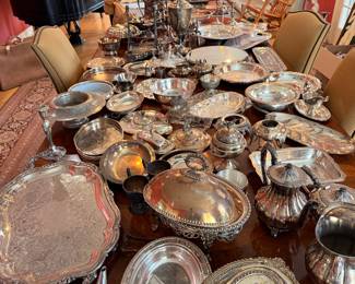An expansive collection of silver serving and decor pieces