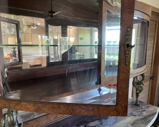 From another era -- check out this beautiful hutch with rounded glass upper cabinet, lower cabinet supported with brass birds and mirror back :)