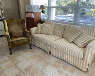 cheerful yellow and white striped sleeper sofa and velvet armchair