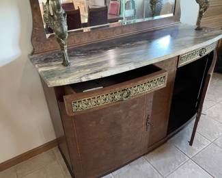From another era -- check out this beautiful hutch with rounded glass upper cabinet, lower cabinet supported with brass birds and mirror back :)