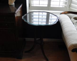 Fancy scroll topped table with matching glass top, hiding in the dark