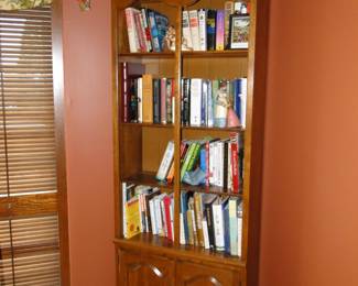 Bookcase with books, and the book case is for sale and all the books are for sale too