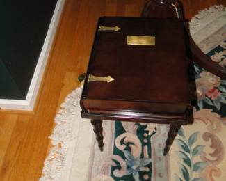 Looks like a book, but it is actually a table, and when you open the book you have storage inside. But take your drink off the top first before you open the book