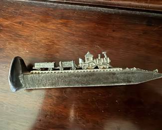 Miniature stem train on a railroad spike