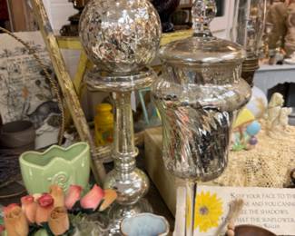 mercury glass decorative sphere on a stand with a matching silver mercury glass jar with a lid