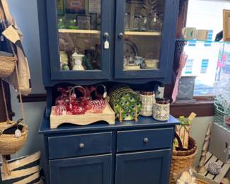 Navy blue china cabinet or hutch, pretty peacock dishes, glassware