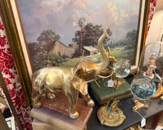 large brass elephant figurine, books, framed art