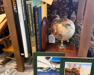 small desk globe, books, coffee table books, metal wall art