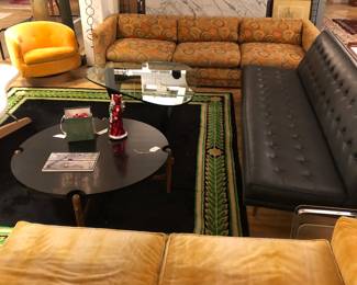 Milo Baughman for Thayer Coggin furnishings including black vinyl sofa & side chair, orange open ended sofa, swivel chair. Large orange sofa is rather worn and has the Thayer Coggin label.