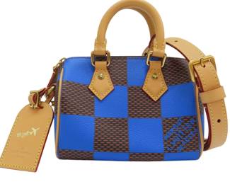 "This stunning Louis Vuitton Speedy 18 Bandouliere handbag is a must-have for fashion enthusiasts. Crafted with iconic Damier canvas in a vibrant blue and brown checkered pattern, this stylish bag features tan leather handles and a detachable shoulder strap for versatile wear. The bag's spacious interior includes pockets for organizing your essentials. Despite being pre-owned, it remains in good condition with minor color fading on the tanned leather. Perfect for everyday use or special occasions, this handbag exemplifies timeless luxury.

Victorins Auctions will coordinate all domestic and international shipping. Please allow approximately 10–15 business days for processing. Certain items may require additional handling time depending on their location, origin, or special packaging requirements. By registering for or placing a bid in a Victorins auction, you confirm that you have reviewed, understood, and agreed to our Shipping, Payment, and Auction Policies."
