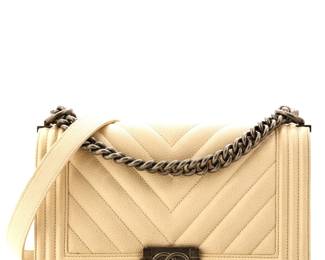 "Up for auction is a coveted Chanel Boy Flap Bag crafted from quilted caviar leather. This iconic medium-sized handbag features a sophisticated neutral exterior complemented by aged silver hardware. With a handle drop of 11 inches and a strap drop of 20 inches, it is both stylish and functional. This bag displays minor scuffs and light wear but remains in very good condition. An authenticity card is included, ensuring its status as a genuine Chanel piece, perfect for any fashion enthusiast.

Victorins Auctions will coordinate all domestic and international shipping. Please allow approximately 10–15 business days for processing. Certain items may require additional handling time depending on their location, origin, or special packaging requirements. By registering for or placing a bid in a Victorins auction, you confirm that you have reviewed, understood, and agreed to our Shipping, Payment, and Auction Policies."
