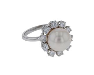 "This exquisite vintage ring features a stunning central cultured pearl elegantly surrounded by a dazzling halo of diamonds. Crafted from a luxurious combination of 18k white gold and platinum, this piece is not only a statement of elegance but also a testament to fine craftsmanship. With a ring size of 52, it weighs 8 grams and includes a total diamond weight of 0.7 carats. The ring's captivating design is perfect for those who appreciate vintage jewelry with a touch of sophistication.

Victorins Auctions will coordinate all domestic and international shipping. Please allow approximately 10–15 business days for processing. Certain items may require additional handling time depending on their location, origin, or special packaging requirements. By registering for or placing a bid in a Victorins auction, you confirm that you have reviewed, understood, and agreed to our Shipping, Payment, and Auction Policies."
