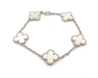 "Discover the timeless elegance of Van Cleef & Arpels with this Vintage Alhambra 5-Motif bracelet. Crafted in exquisite 18K white gold, it features five captivating clover motifs made of luminous white mother-of-pearl. This bracelet not only embodies sophistication but also represents the maison’s iconic symbol of luck. In excellent pre-owned condition, with minimal wear, it's perfect for collectors and daily wear alike. The bracelet includes its original Van Cleef & Arpels box, ensuring its authenticity and delicate beauty is preserved for years to come.

Victorins Auctions will coordinate all domestic and international shipping. Please allow approximately 10–15 business days for processing. Certain items may require additional handling time depending on their location, origin, or special packaging requirements. By registering for or placing a bid in a Victorins auction, you confirm that you have reviewed, understood, and agreed to our Shipping, Payment, and Auction Policies."
