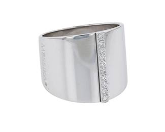 "Discover the exquisite Messika Kate ring, crafted from luxurious 18k white gold and adorned with shimmering diamonds. This modern piece features a sleek design with a vertical line of diamonds, totaling 0.2 ct, expertly showcasing the brilliance of each gem. Weighing 11.2 grams and measuring 1.7 cm in width, this ring offers a size 54 fit, with the potential for resizing. Each detail reflects Messika's dedication to elegance and craftsmanship, making it a perfect addition to any jewelry collector's ensemble.

Victorins Auctions will coordinate all domestic and international shipping. Please allow approximately 10–15 business days for processing. Certain items may require additional handling time depending on their location, origin, or special packaging requirements. By registering for or placing a bid in a Victorins auction, you confirm that you have reviewed, understood, and agreed to our Shipping, Payment, and Auction Policies."

