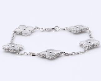 "This exquisite Van Cleef & Arpels Vintage Alhambra bracelet is a stunning piece of jewelry crafted in 18K white gold. It features five clover motifs, each delicately engraved with radiant sunburst lines that create a beautiful shimmer in varying light. The intricate design and craftsmanship reflect the Maison's dedication to elegance and luck. This elegant bracelet is not only a symbol of harmony but also a testament to timeless luxury. It includes the original Van Cleef & Arpels presentation box and is in excellent pre-owned condition.

Victorins Auctions will coordinate all domestic and international shipping. Please allow approximately 10–15 business days for processing. Certain items may require additional handling time depending on their location, origin, or special packaging requirements. By registering for or placing a bid in a Victorins auction, you confirm that you have reviewed, understood, and agreed to our Shipping, Payment, and Auction Policies."
