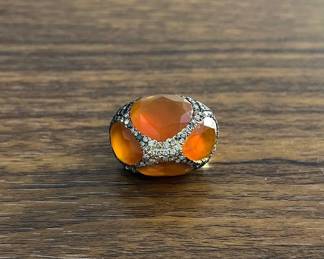 "This exquisite 14K gold statement ring features a breathtaking 23.64-carat faceted orange carnelian at its center. The vibrant gemstone is beautifully complemented by 1.86 carat total weight of dazzling diamonds that encircle the setting, adding a touch of brilliance and sophistication. Crafted with intricate detailing, this ring showcases the artisan's exceptional skill and attention to detail. A true embodiment of timeless elegance, it is perfect for special occasions or as a luxurious addition to any jewelry collection.

Victorins Auctions will coordinate all domestic and international shipping. Please allow approximately 10–15 business days for processing. Certain items may require additional handling time depending on their location, origin, or special packaging requirements. By registering for or placing a bid in a Victorins auction, you confirm that you have reviewed, understood, and agreed to our Shipping, Payment, and Auction Policies."
