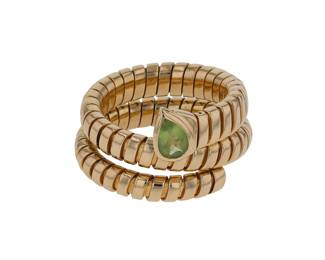 "This exquisite Bulgari Serpenti Tubogas ring showcases an elegant and flexible design, reminiscent of a coiling serpent. Crafted from 18k yellow gold, it features a stunning green peridot gemstone that adds a vibrant touch. With a ring size of 57, the band measures 1.7 cm in width and 0.4 cm in thickness, making it a statement piece for any jewelry collection. Doubling as both a symbol of luxury and artistry, this vintage ring captures the essence of Bulgari's innovative spirit. A must-have for collectors and connoisseurs alike.

Victorins Auctions will coordinate all domestic and international shipping. Please allow approximately 10–15 business days for processing. Certain items may require additional handling time depending on their location, origin, or special packaging requirements. By registering for or placing a bid in a Victorins auction, you confirm that you have reviewed, understood, and agreed to our Shipping, Payment, and Auction Policies."
