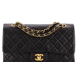 "This Chanel Medium Vintage Classic Double Flap Bag in black lambskin exudes timeless elegance and luxury. The exterior features a quilted design with visible signs of wear, including corner and edge scuffs, while the gold hardware adds to its opulence. The interior, lined in rich red leather, shows slight discoloration and minor marks, but overall maintains the signature Chanel flair. With a versatile strap drop of 15 inches, this bag is perfect for both casual and formal occasions. Accessories include an authenticity card.

Victorins Auctions will coordinate all domestic and international shipping. Please allow approximately 10–15 business days for processing. Certain items may require additional handling time depending on their location, origin, or special packaging requirements. By registering for or placing a bid in a Victorins auction, you confirm that you have reviewed, understood, and agreed to our Shipping, Payment, and Auction Policies."

