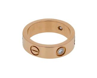 "Discover the timeless elegance of the Cartier Love ring, a stunning piece crafted from 18k yellow gold and accented with exquisite diamonds. This modern design, created circa 2009, features a distinctive band with delicate diamond settings and iconic screw motifs that signify everlasting love. Weighing 7.8 grams and measuring 0.5 cm in width, this ring is a true statement piece. The diamond weight of 0.22 ct adds a touch of brilliance, showcasing Cartier's commitment to luxury and quality.

Victorins Auctions will coordinate all domestic and international shipping. Please allow approximately 10–15 business days for processing. Certain items may require additional handling time depending on their location, origin, or special packaging requirements. By registering for or placing a bid in a Victorins auction, you confirm that you have reviewed, understood, and agreed to our Shipping, Payment, and Auction Policies."
