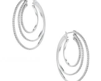 "This exquisite pair of modern earrings showcases a stunning design of intertwined hoops crafted from luxurious 18k white gold and adorned with sparkling diamonds. Weighing 16.8 grams, the earrings boast a diamond weight of 1.4 carats, providing a dazzling accent to any attire. Measuring 4.3 cm in width and length, these pierced earrings offer both sophistication and comfort. Perfect for special occasions or everyday wear, they are a statement piece that combines elegance and contemporary flair.

Victorins Auctions will coordinate all domestic and international shipping. Please allow approximately 10–15 business days for processing. Certain items may require additional handling time depending on their location, origin, or special packaging requirements. By registering for or placing a bid in a Victorins auction, you confirm that you have reviewed, understood, and agreed to our Shipping, Payment, and Auction Policies."
