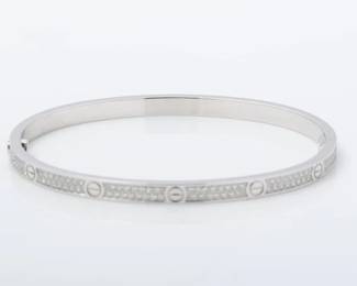 "This exquisite Cartier Love Diamond Thin Bracelet is a true representation of elegance and luxury. Crafted from solid 18K white gold, it showcases the iconic Love design adorned with shimmering pavé-set diamonds. The thin bangle offers a delicate touch, making it perfect for everyday wear or special occasions. Accompanied by its original presentation box, this bracelet is in very good pre-owned condition and has been authenticated through a thorough serial number check. A must-have for any jewelry enthusiast and a timeless addition to your collection.

Victorins Auctions will coordinate all domestic and international shipping. Please allow approximately 10–15 business days for processing. Certain items may require additional handling time depending on their location, origin, or special packaging requirements. By registering for or placing a bid in a Victorins auction, you confirm that you have reviewed, understood, and agreed to our Shipping, Payment, and Auction Policies."
