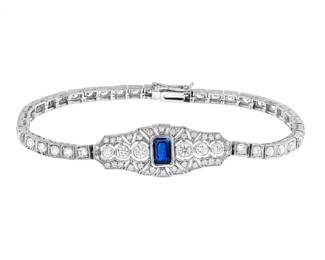 "This exquisite Art Deco inspired bracelet features a stunning 1.4 carat emerald-cut blue sapphire at its center, radiating a captivating hue that draws the eye. Surrounding the sapphire are 76 round diamonds that create an elegant sparkle, enhancing the bracelet's overall appeal. Crafted in 14K white gold, this piece measures 185 mm in length and 13 mm in width, making it a perfect accessory for any occasion. Weighing approximately 14.94 grams, this bracelet is not just a piece of jewelry but a work of art that is sure to be admired.

Victorins Auctions will coordinate all domestic and international shipping. Please allow approximately 10–15 business days for processing. Certain items may require additional handling time depending on their location, origin, or special packaging requirements. By registering for or placing a bid in a Victorins auction, you confirm that you have reviewed, understood, and agreed to our Shipping, Payment, and Auction Policies."
