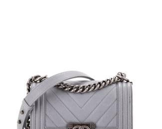 "This exquisite Chanel Boy Flap Bag features a stunning gray chevron caviar leather exterior, combining elegance with functionality. The bag, designed with attention to detail, showcases its signature aged silver hardware, adding a touch of sophistication. Its interior includes a gray fabric lining, ensuring a luxe experience. Despite minor scuffs and wear on the corners and strap, the bag remains in very good condition. Accompanied by a dust bag and authenticity card, this timeless piece is perfect for any fashion enthusiast.

Victorins Auctions will coordinate all domestic and international shipping. Please allow approximately 10–15 business days for processing. Certain items may require additional handling time depending on their location, origin, or special packaging requirements. By registering for or placing a bid in a Victorins auction, you confirm that you have reviewed, understood, and agreed to our Shipping, Payment, and Auction Policies."
