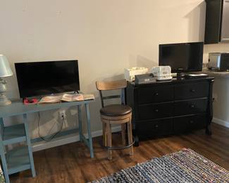 Two flat screen TV’s, a really nice dresser and oh yes - one bar stool!! 
