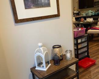 Industrial style table and several candle holders plus a large supply of candles
