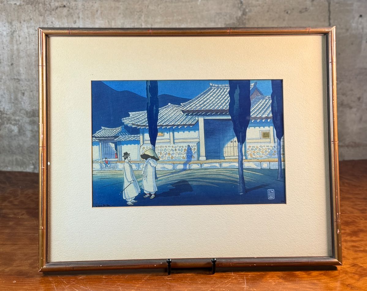 "Korean Farmhouse by Moonlight", an exceptional Japanese woodblock print by listed artist, Lilian May Miller. This rare copy features Miller’s signature lower left in pencil, along with the limited edition run, numbered 1/10. This piece measures in the frame, 15” H x 19” W and out of the frame, 10.75” H x 15.25” W. This woodblock was created in 1928 and this artwork is part of the collection of the National Museum of Asian Art. Lilian May Miller was an American painter and printmaker born in Tokyo, Japan, who studied traditional Japanese wood printing techniques.