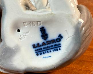 This lot features a porcelain figurine titled, "Cat and Mouse", manufactured by Lladro (model number 5236) & a cat themed trinket box manufactured by Bilston and Battersea. Bilston and Battersea enamels are fine English enamelware, originally produced in the 18th century and revived in the 20th century, known for decorative items like trinket boxes, pillboxes, and other luxury goods
