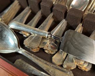 This lot features a stunning set of flatware by Christofle for Neiman Marcus. Each piece is beautifully marked as shown in photos, accompanied with Neiman Marcus covers, and housed in a vintage flatware box for safe storage. Christofle was founded in Paris in 1830 by Charles Christofle, who gained a reputation for his innovative silver plating technology and became a purveyor to the French court. The company grew significantly, supplying its flatware to royalty and even making its mark at international exhibitions, earning awards until at least 1937. Key moments in its history include acquiring the patents for electroplating in 1842, creating the America flatware collection in 1933, and introducing the Aria collection in 1985. 
This set includes two (2) large spoons, one (1) server, one (1) large fork, three (3) knives, twelve (12) big spoons, twelves (12) big forks, twelve (12) standard spoons, and eight (8) standard forks.