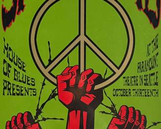 This lot features a concert poster for Michael Franti & Spearhead, designed and signed by artist, Justin Hampton. Limited edition, numbered 94/150 and measures, 25.5” H x 17.5” W. The concert was presented by the House of Blues and took place at the Paramount Theatre in Seattle. 
