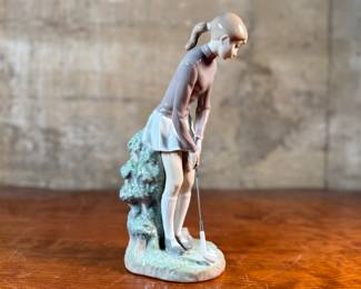 "Lady Golfer", a vintage retired Lladro porcelain figurine, model number 4851. This sculpture is in excellent condition and measures, 11” H x 4” W x 5” D.
