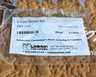 The Las Vegas lot! This lot features two coins featuring .999 fine silver, a bag of proof nickels, a new sealed card set, three (3) silver certificates, and a Baccarat table cover from The Hilton in Las Vegas.
