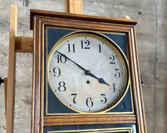This lot features an antique clock made by the Waterbury Clock Company, with an advertising glass panel for Macdonald Jewelry Company. Appears complete with key, pendulum, instructions, and service records. This clock measures, 35” H x 16” W x 5” D. The Waterbury Clock Company factory is a historic complex of factory buildings in Waterbury, Connecticut. Development began in 1873, with the extensive plant serving as the company’s main manufacturing facility and headquarters until 1944.
