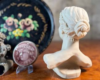 This lot features a collection of antiques and collectibles including sculpture, brass candlesticks, a Zwaro pottery vase, and more.
