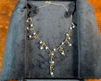 This lot features a stunning vintage 10k gold necklace with various stones including Amethyst, Peridot, Pearl, Blue Topaz, & Citrine, measuring 18” with a total approx. weight of 11.26 grams. Comes in a fancy presentation case and marked 10k as shown in photos.
