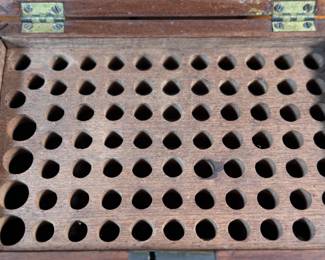 This lot features an antique wooden homeopathic apothecary box used to store various vials of homeopathic remedies. This box measures, 2.75” H x 7.75” W x 5” D.
