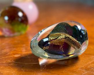 This lot features an assortment of blown glass items including a Murano perfume bottle, an artist signed paperweight, and more.
