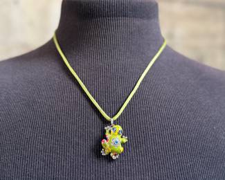 This lot features a Belle Étoile Lucky Frog pendant featuring hand-painted enameling in green, yellow, red, and blue. The pendant is made of sterling silver and marked 925 on the back as shown in photos. The pendant measures, 1.25” H x 1” W with a total approx. weight of 15.00 grams.
