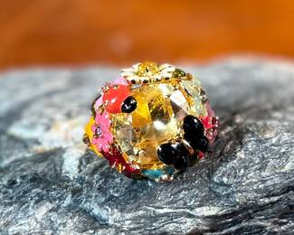 This lot features a reproduction of a ladybug floral enamel gold ring, originally made in 18k by Dior. This piece is believed to be a quality reproduction and is made of sterling silver. Marked 925 and comes in a size 8.
