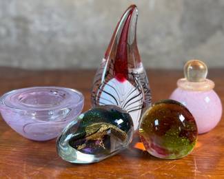This lot features an assortment of blown glass items including a Murano perfume bottle, an artist signed paperweight, and more.
