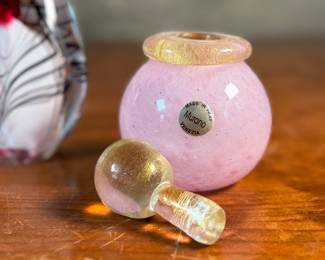 This lot features an assortment of blown glass items including a Murano perfume bottle, an artist signed paperweight, and more.
