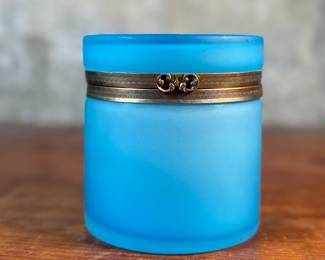 This lot features a vintage French blue opaline glass lidded keepsake box with brass trim that measures, 5” H x 4.75” W x 4.75” D. One small interior crack as shown in photos.
