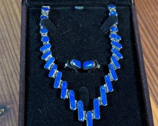 This lot features a stunning silver Lapis graduated necklace and earring set, circa 1960s. Marked .970 silver as shown in photos with a total approx. weight of 42.14 grams. The necklace measures 18” and comes in a nice presentation box.

