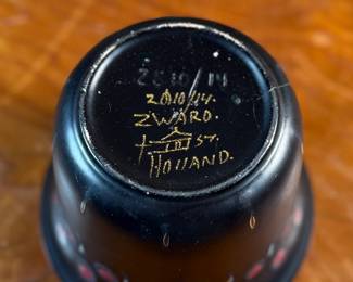 This lot features a collection of antiques and collectibles including sculpture, brass candlesticks, a Zwaro pottery vase, and more.
