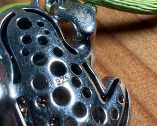 This lot features a Belle Étoile Lucky Frog pendant featuring hand-painted enameling in green, yellow, red, and blue. The pendant is made of sterling silver and marked 925 on the back as shown in photos. The pendant measures, 1.25” H x 1” W with a total approx. weight of 15.00 grams.
